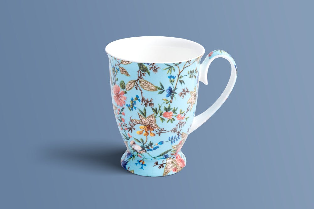 Botanica Blue footed bone china mug with fine branching stems and cream-veined leaves on powder blue.