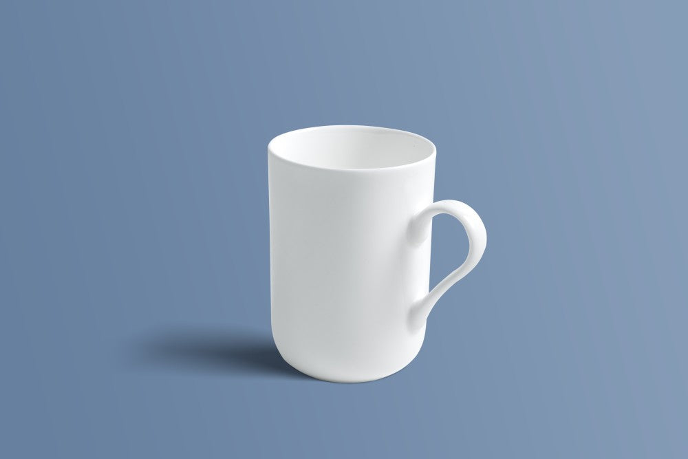 Plain white bone china mug shown from the side in the same tall tapered silhouette.