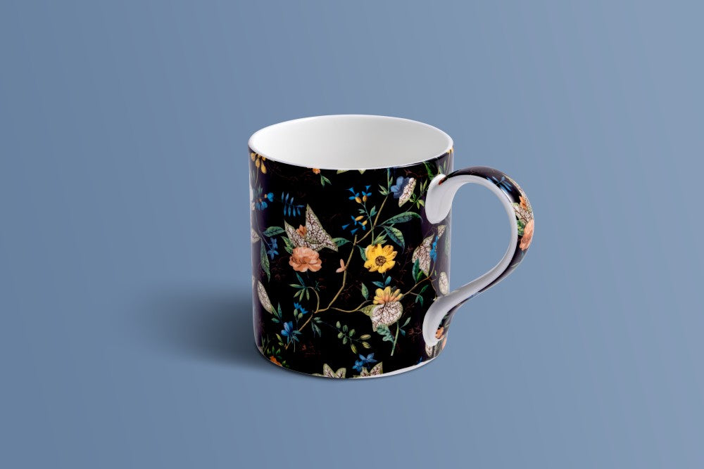Botanica Noir bone china mug with trailing stems and blooms in ochre, blush and blue on black.