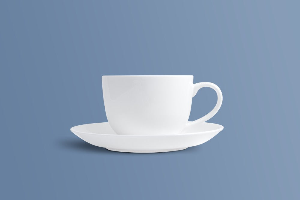 Plain white bone china coffee cup with its matching saucer, shown from the side.