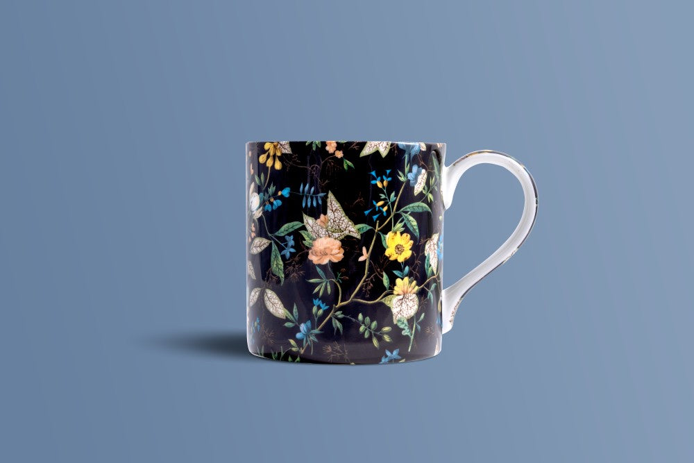 Botanica Noir bone china coffee mug shown from the side, dense botanical pattern on a dark ground.