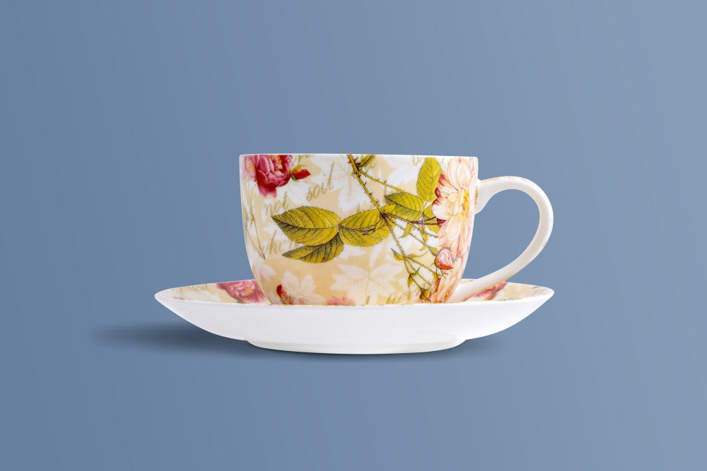 Rose & Verse bone china coffee cup and saucer, garden roses and green leaves on warm cream.