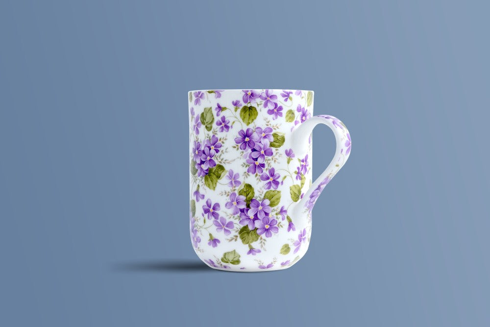 English Violet bone china mug with the patterned handle in view, purple violets on white.