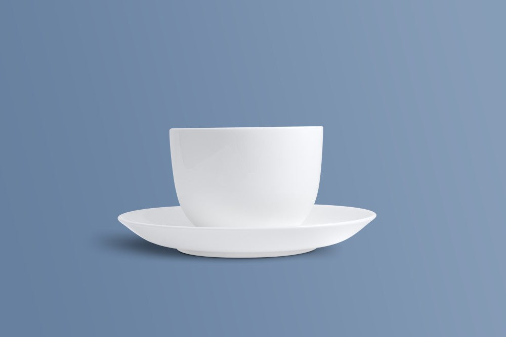 Plain white bone china coffee cup and saucer, plain undecorated glaze.