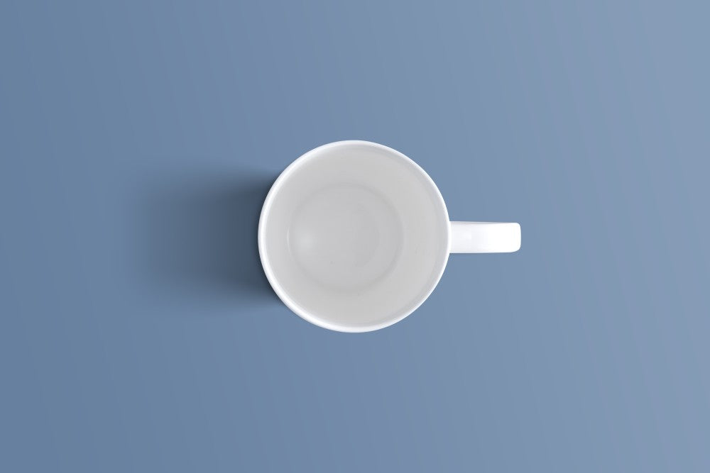Top-down view of the plain white bone china coffee mug and its handle.