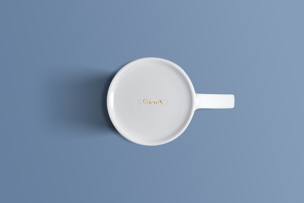 Plain white bone china mug viewed from above, with the Otava mark inside the base.
