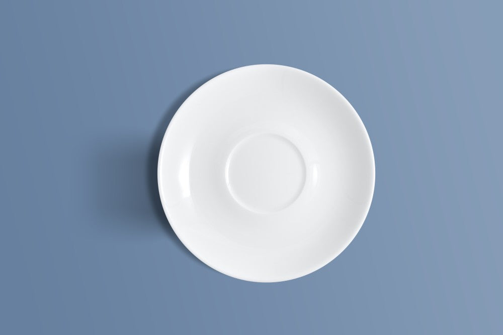Plain white bone china saucer photographed from above on a plain background.