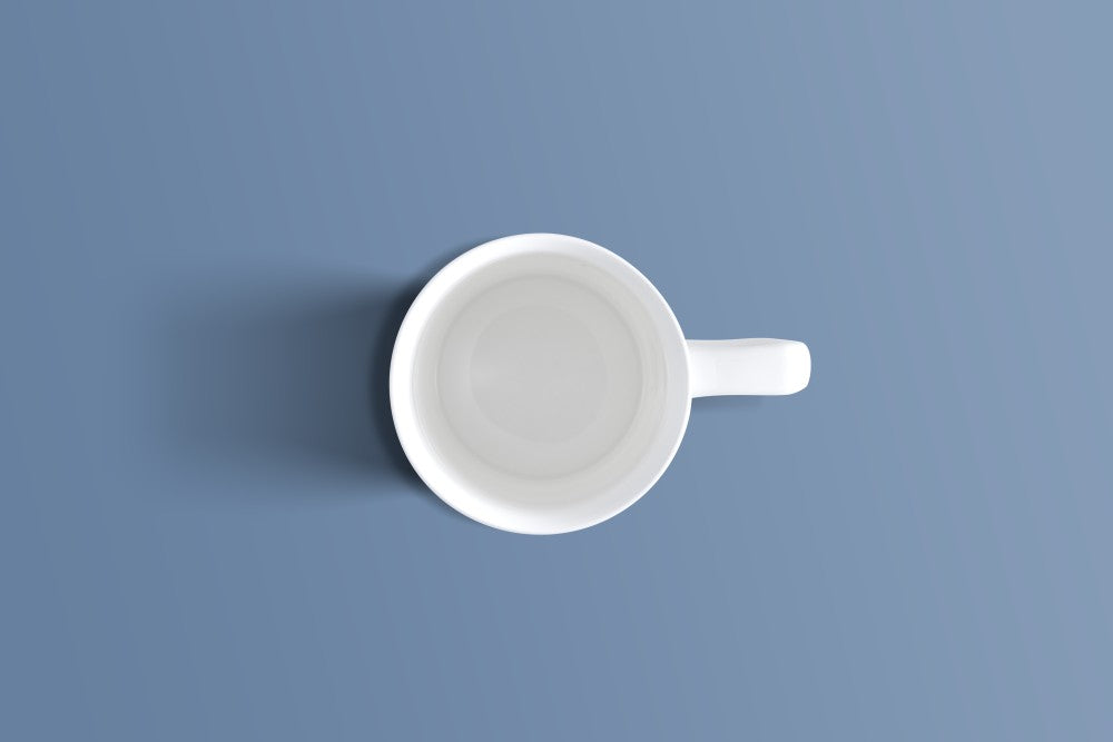 Overhead view of the plain white bone china coffee mug and its handle.