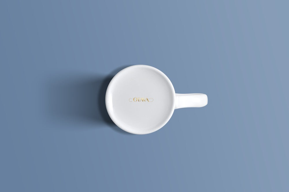 Plain white bone china mug viewed from above, with the Otava mark inside the base.