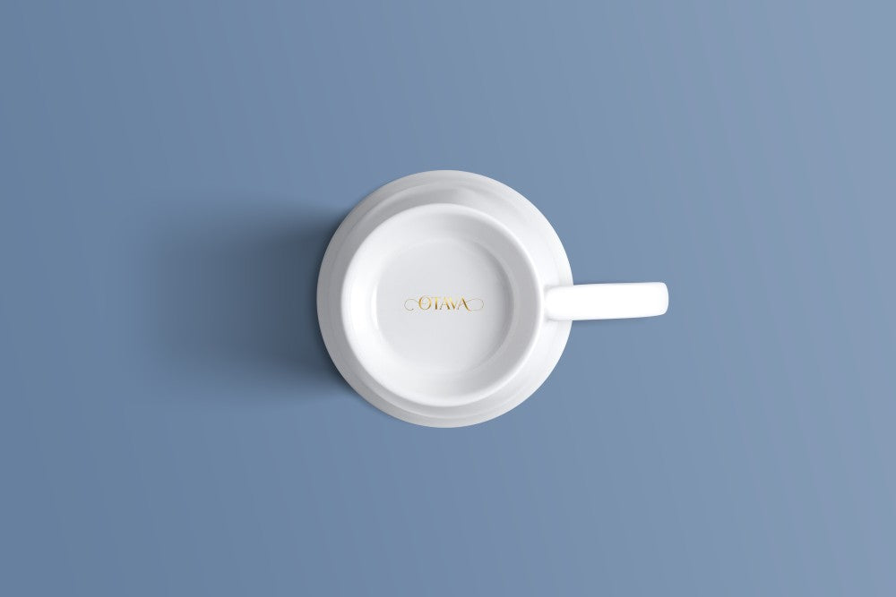 Plain white bone china mug viewed from above, with the Otava mark inside the base.