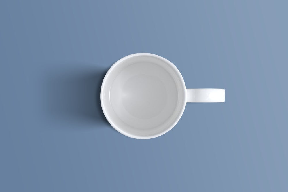 Overhead view of the plain white bone china coffee mug and its handle.