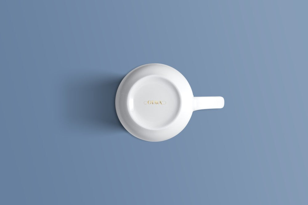 Plain white bone china mug viewed from above, with the Otava mark inside the base.