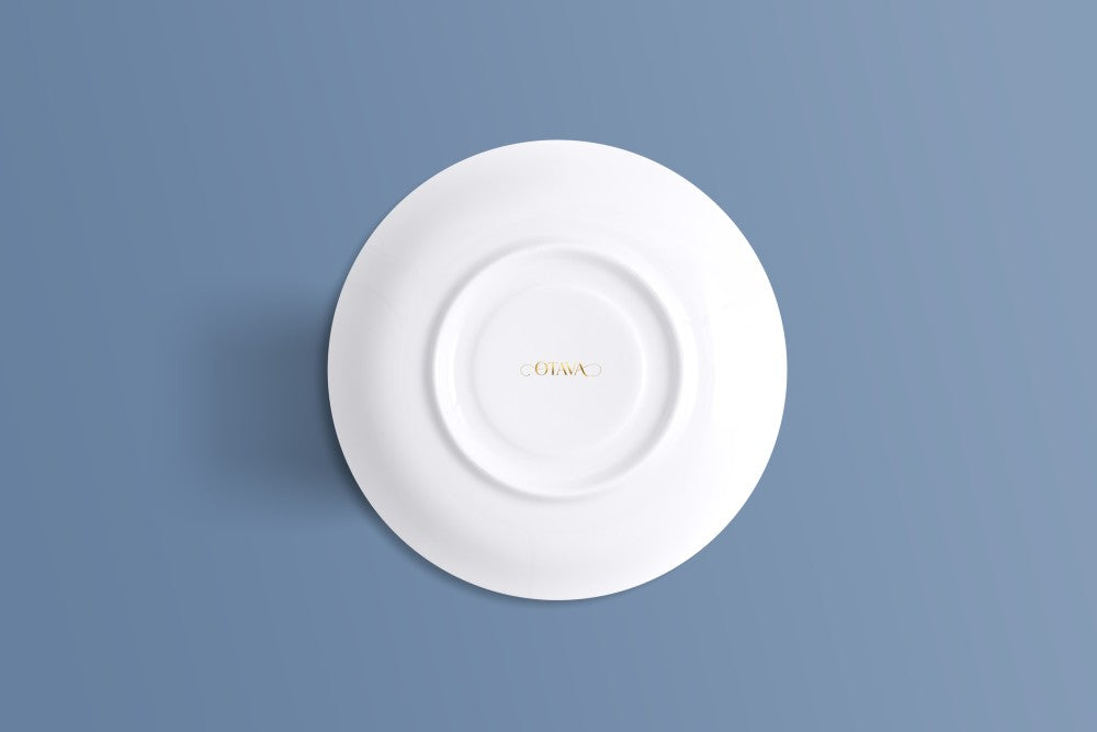 Plain white bone china saucer with a small gold Otava mark at the centre.