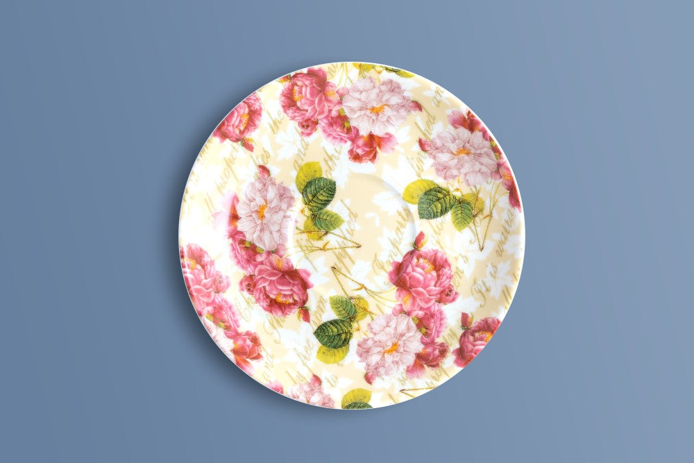 Rose & Verse bone china saucer with pink and white roses and green leaves on cream.