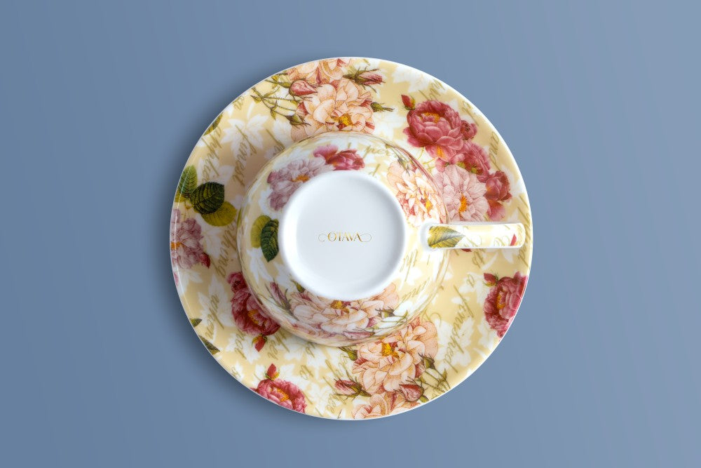 Rose & Verse bone china cup and saucer from above, with the Otava mark in gold inside the cup.