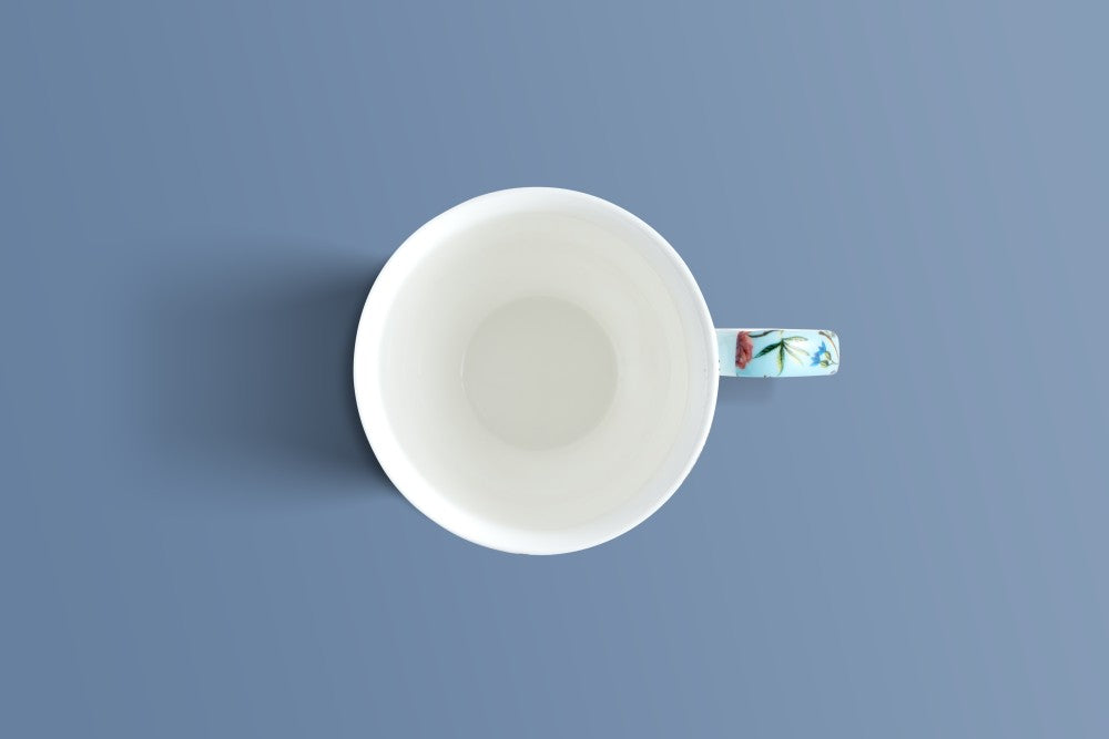 Overhead view of the Botanica Blue bone china mug showing its patterned handle.