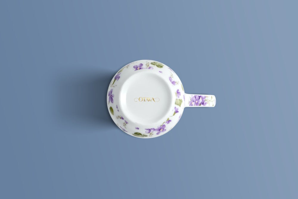 English Violet bone china mug viewed from above, violet pattern around the rim and the Otava mark inside the base.