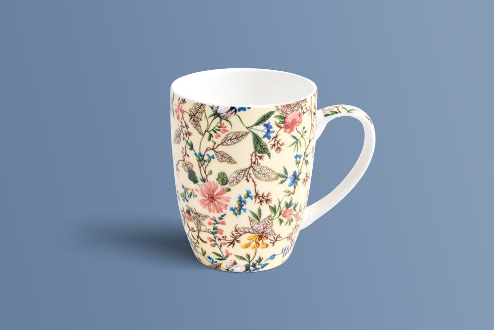 Botanica Cream bone china mug with pink, blue and yellow flowers and green leaves on a cream ground.