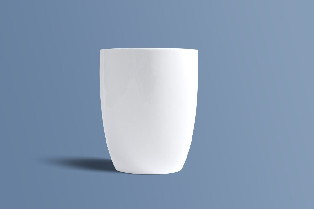Plain white bone china mug seen from the back, showing its tall tapered profile.