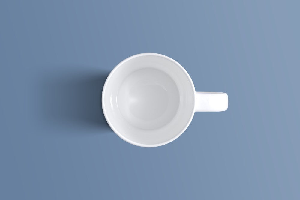 Top-down view of the plain white bone china coffee mug and its handle.