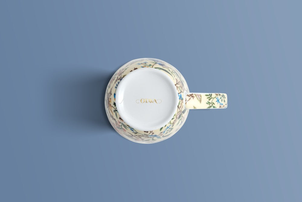 Botanica Cream bone china mug viewed from above, floral border and the Otava mark inside the base.