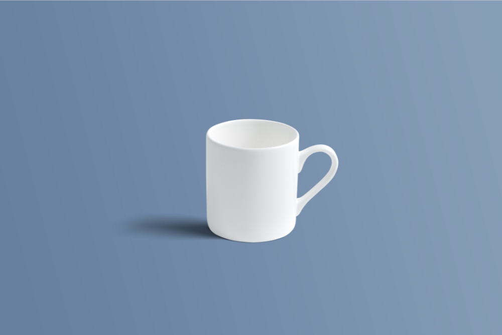 A plain white ceramic coffee mug with a handle, shown on a solid slate blue background.